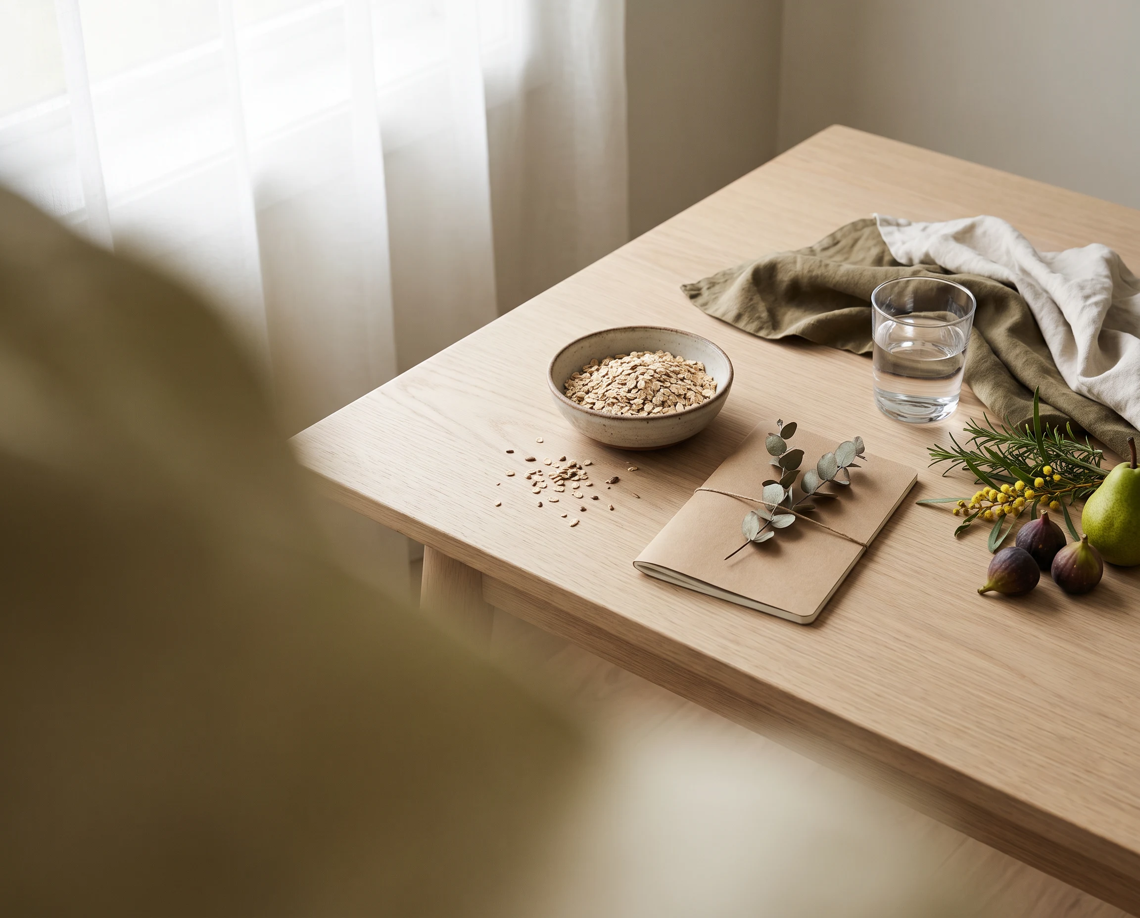 Fresh produce, oats, water and natural materials arranged for a naturopathy wellness consultation.