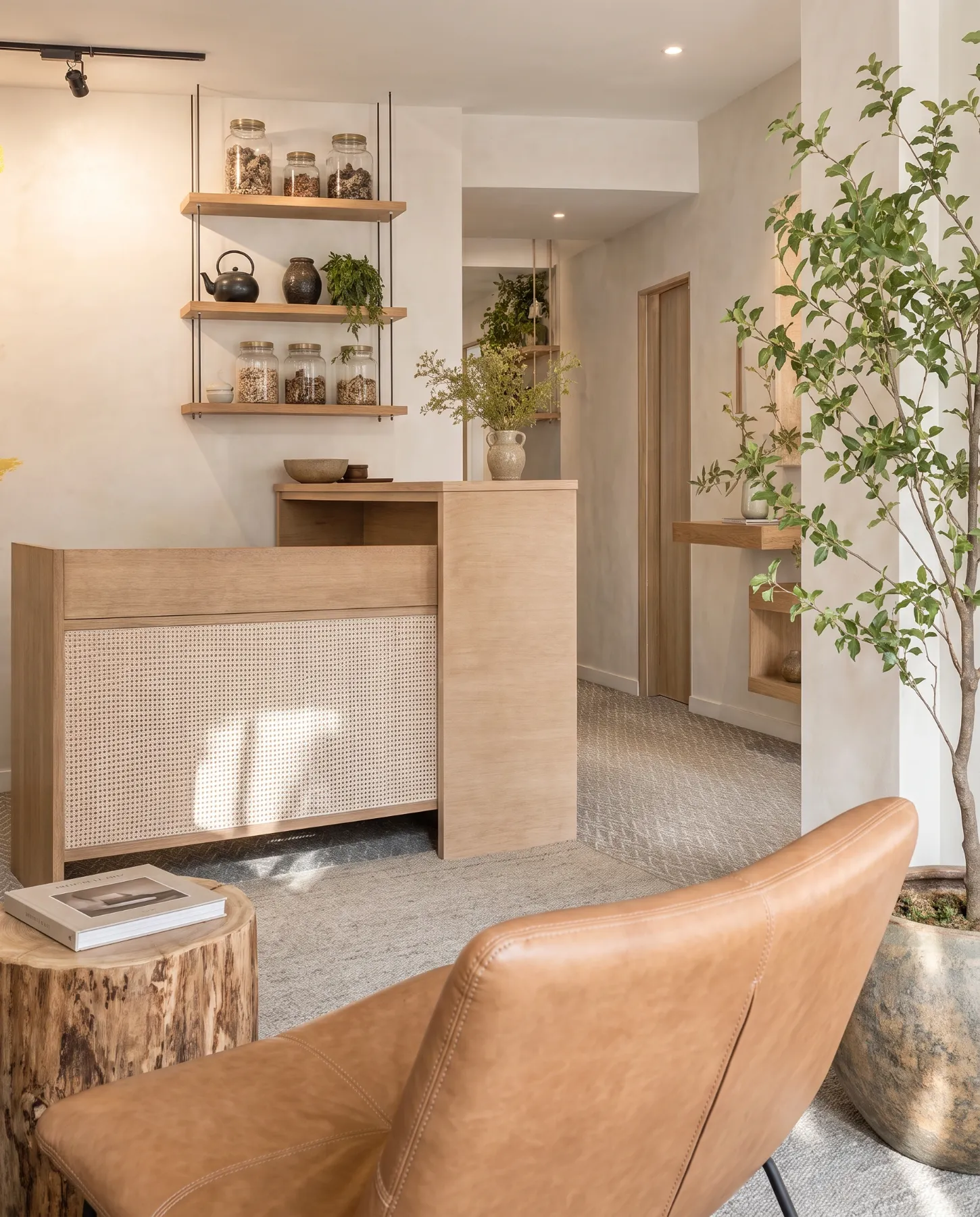 Welcoming clinic waiting area with tan lounge chair, timber reception desk and indoor plants